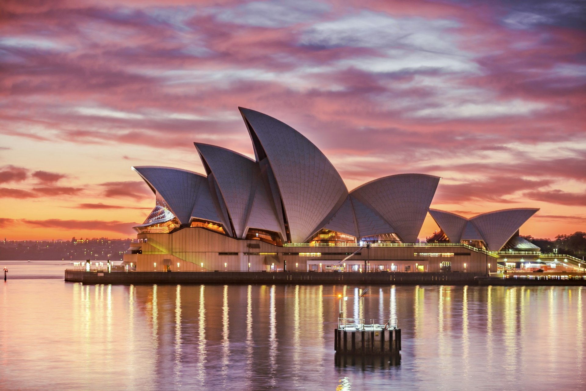 The Sydney Opera House and Harbour Bridge at golden hour.